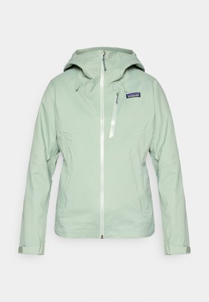 Šviesiai žalia neperšlampama striukė iš tekstūruotos medžiagos, su gaubtu, pilnu priekiu užtrauktuku ir mažu logotipu kairėje krūtinės pusėje.