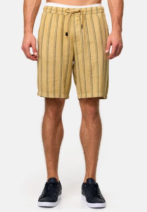 Lysegule stripete shorts laget av teksturert stoff, med elastisk liv med snor og sidelommer.
