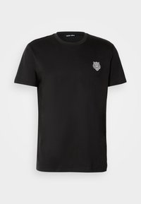 Black cotton t-shirt with a crew neck and short sleeves, featuring a textured graphic of a tiger's head on the left chest.
