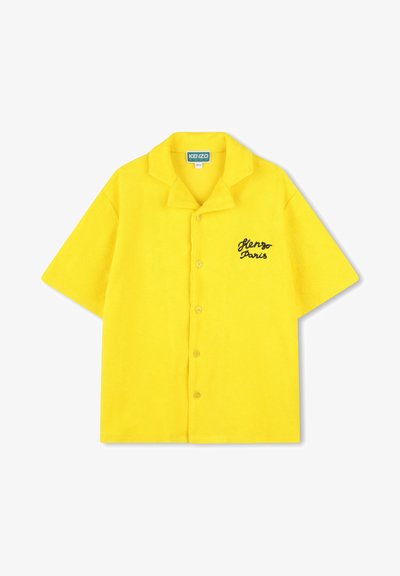 Korte mouwen, overhemd met knopen in felgele terrystof. Kenmerkt zich door een puntige kraag en "Kenzo Paris" geborduurd in het zwart op de borst.