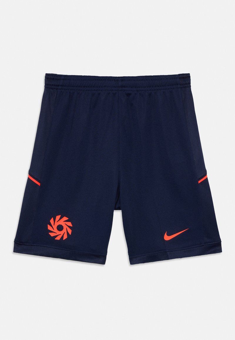 Tumši zili sporta šorti ar elastīgu jostu, sarkans Nike švīka labajā kājā un sarkans apļa logo kreisajā kājā.