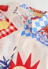 Unselected, cream red map print
