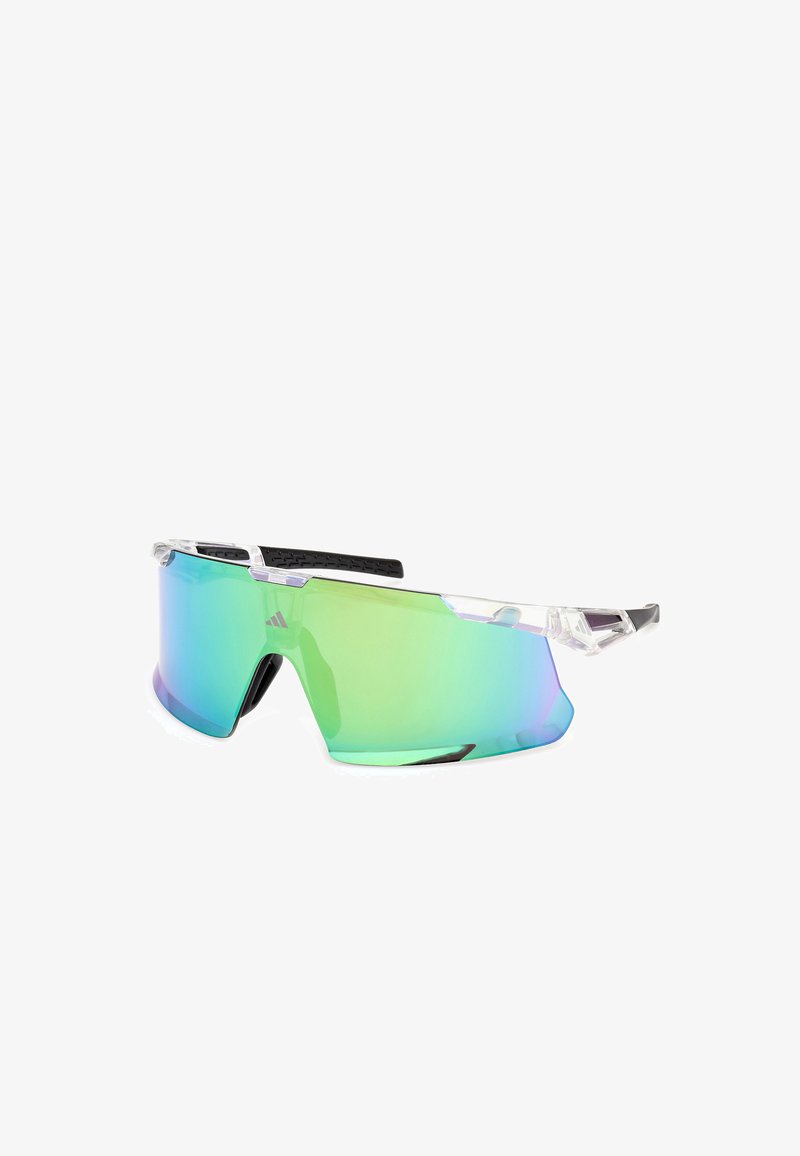 Lunettes de sport angulaires avec une monture transparente et des verres dégradés verts. Équipées de branches en caoutchouc noir texturé pour un confort optimal.