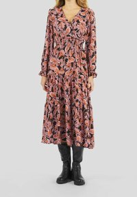 Vestido maxi floral en negro, rosa y naranja. Presenta mangas largas, escote en V y falda en capas. El material parece ligero con una textura suave.
