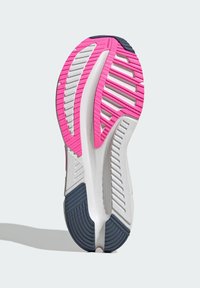 Shoe sole featuring a pink and white design with grooves and patterns; navy rubber accents enhance grip and stability.