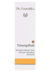 Dr. Hauschka Tönungsfluid packaging, tall rectangular box, predominantly white with silver text, orange base, and a circular color indicator.