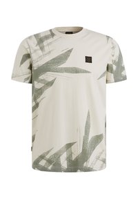 T-shirt en coton crème avec un motif de feuilles vertes, manches courtes, et une petite étiquette noire sur la poitrine pour le branding.