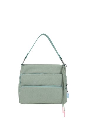 Light green fabric shoulder bag with two front zippered pockets and a knotted decorative tassel on the right side.