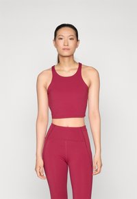 Bordeaux välsittande träningscrop top med breda band, kombinerad med matchande högmidjade leggings med sömdetaljer.