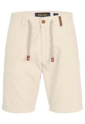 Beige herenshorts van katoen. Voorzien van een verstelbare taille met bruine leren accenten en een knoopsluiting aan de voorkant. Soepele textuur, knielange snit.