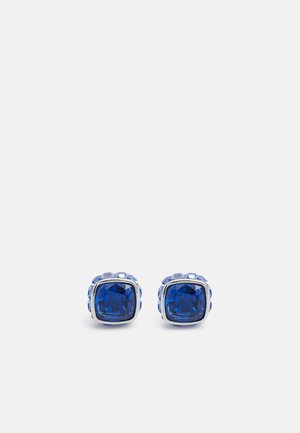 Blue gemstone stud earrings set in a silver-tone metal with a square shape, featuring a faceted surface and a polished finish.
