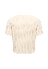 Haut en maille dentelle à manches courtes de couleur crème avec bords festonnés, vu de dos sur fond blanc.