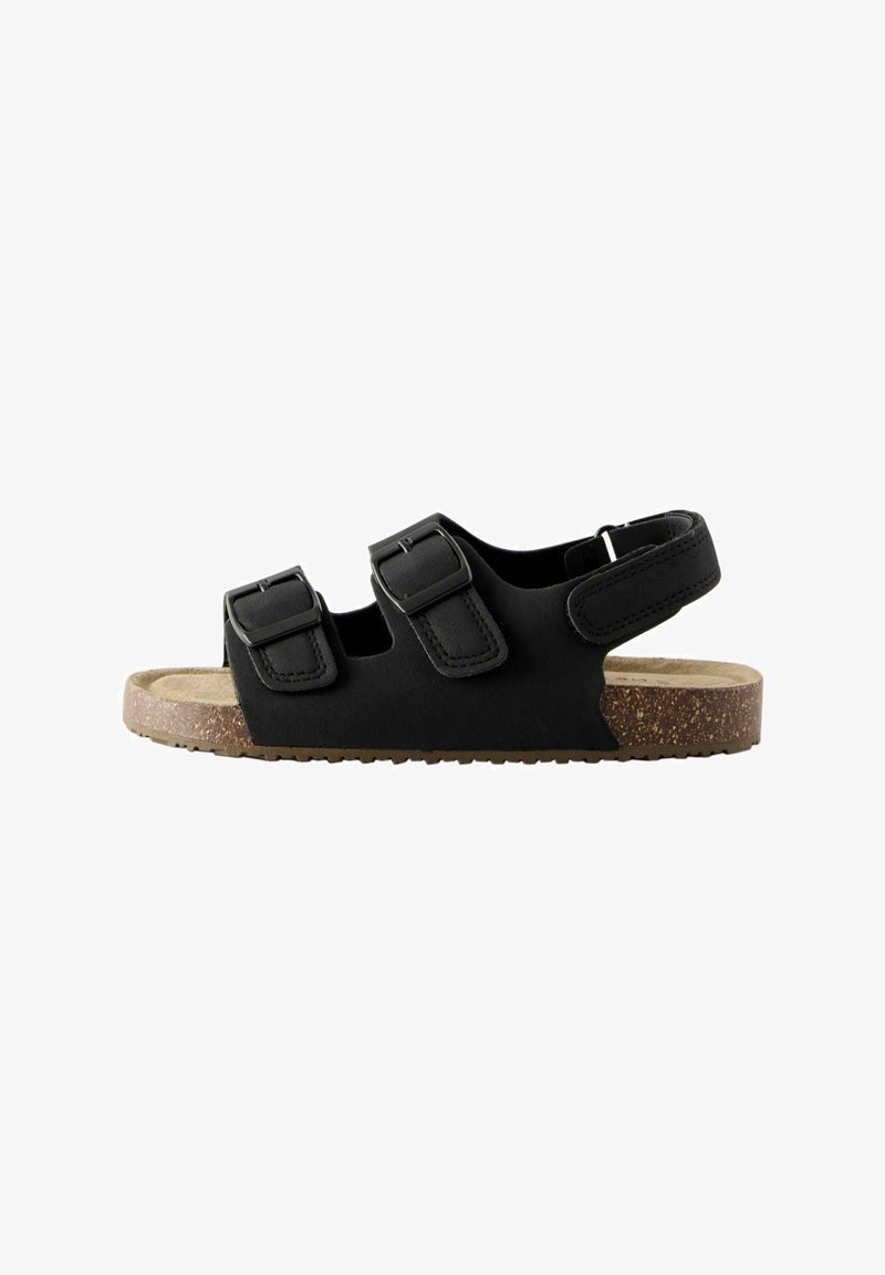 Black sandal with two adjustable buckles, cork sole, and textured straps. Open back design for ventilation and comfort.