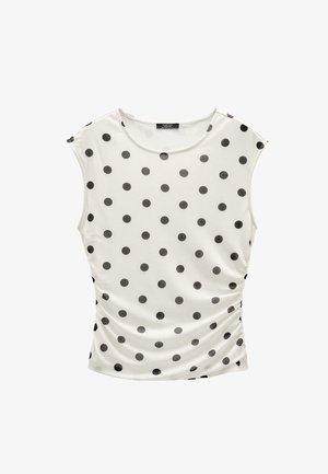 Biała bezrękawnikowa bluzka w czarne kropki z marszczeniami po bokach, z okrągłym dekoltem.