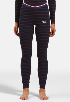 Close-up of a person wearing navy blue leggings with red horizontal stripes and a white "Odlo" logo on the upper thigh.