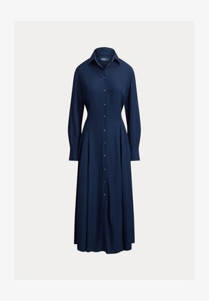 Robe chemise bleu marine avec col, manches longues et jupe plissée. Confectionnée dans un tissu lisse, présentant une silhouette classique.