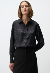 Black satin shirt featuring a floral pattern in dark gray, long sleeves, a collared neckline, and button closures down the front.