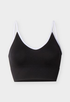 Sort cropped bralette med hvit kant og tynne doble skulderstropper på en lys grå bakgrunn.