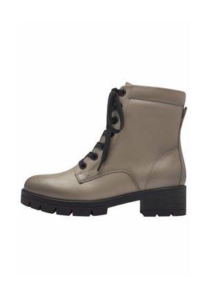 Women's ankle boots made of beige leather with a smooth finish, featuring black laces, a block heel, and a rugged sole design.
