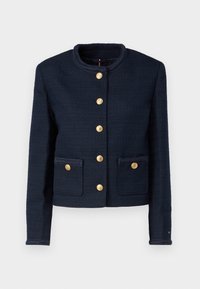 Navy blue cropped jacket in textured fabric, featuring a rounded collar, gold buttons, and two front pockets with decorative trim.