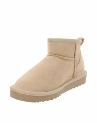 Botín de ante beige hasta el tobillo con punta redonda, detalles de costura, interior suave y suela de goma, que cuenta con un pequeño lazo trasero para facilitar su uso.