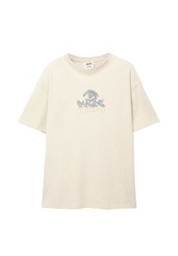 Béžové bavlnené tričko s voľným strihom, so grafickým dizajnom oka nad textom "Magické draky" v modrej a zlatej farbe.