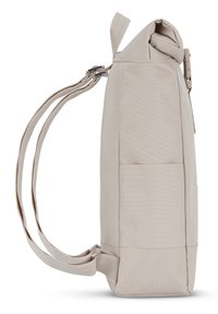 Beige backpack with a structured design, adjustable straps, a side pocket, and a slightly textured fabric finish. Rolled top closure.