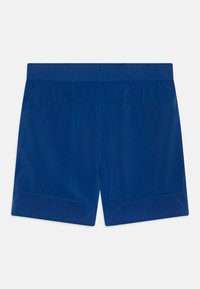 Blue athletic shorts made of lightweight fabric with a smooth texture. Features a patterned bottom hem and an elastic waistband.