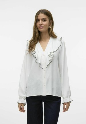 Witte blouse met gerimpelde kraag afgewerkt met zwart, met een V-hals, knoopsluiting aan de voorkant en lange mouwen met gerimpelde manchetten.