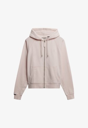 Sudadera de cremallera en rosa claro hecha de un tejido suave. Cuenta con una capucha con cordón, bolsillos tipo canguro y puños acanalados. Branding minimalista en el pecho.