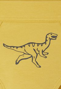 Gelbes Gewebe mit einem gedruckten blauen Dinosaurierdesign. Der Dinosaurier geht mit einem markanten Kopf und Schwanz, der mit Streifen detailliert ist.