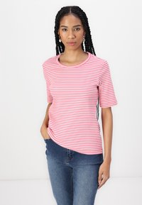 Pink and white striped short-sleeve t-shirt with a round neckline, paired with blue jeans. Smooth fabric with a slight stretch.