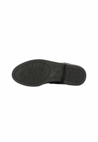 Suola di scarpa in gomma nera con un motivo di presa testurizzato, caratterizzata da un tacco piatto e largo e un design del battistrada per una buona aderenza.