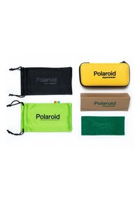 Custodie per occhiali Polaroid: bustina morbida nera, bustina morbida verde con accento arcobaleno, custodia rigida gialla, scatola di cartone marrone, bustina morbida verde scuro.