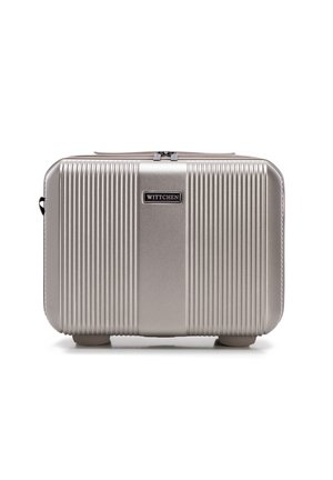 Silver hard-shell cosmetic case featuring vertical ridges, a central smooth panel, and a logo plate, with a zip closure and rounded corners.