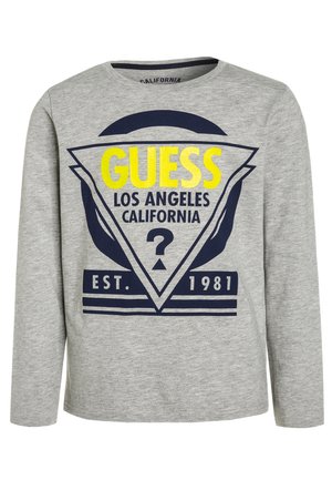 Jasnoszara koszula z długim rękawem z granatowym i jaskrawożółtym logo „GUESS Los Angeles California” oraz napisem „EST. 1981” na przedzie.