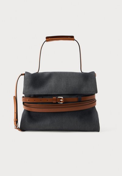 Dark gray fabric bag with a structured shape, featuring a brown leather handle and strap, and a belt-like accent for closure.