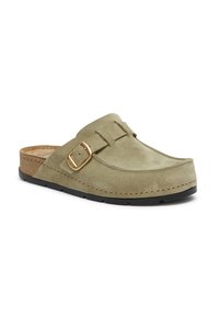 Gröna mocka slip-on träskor med korksula, som har ett guldtonat spänne och sömdetaljer längs kanterna för extra struktur.