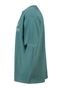 Turkoosi puuvillapaita, jossa on lyhyet hihat ja pyöreä kaula-aukko, etuosassa valkoisella tekstillä "YHTEISKUNTA".