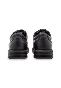 Black leather shoes with a rounded toe, low-profile design, padded collar, textured side accents, and thick rubber outsole.