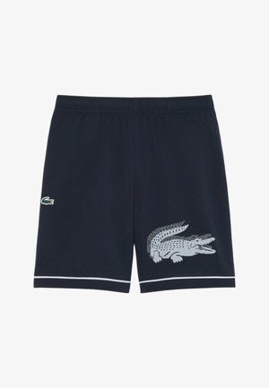 Shorts blu navy con vita elastica, bordi bianchi e due loghi di coccodrillo: piccolo sulla coscia sinistra e grande decorato sulla coscia destra.