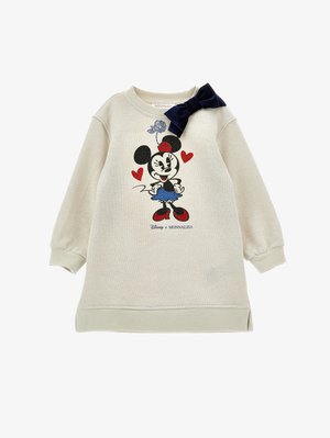 Lichtbeige sweatshirt jurk met een cartoonfiguurprint. Heeft een marineblauwe strikaccent op de schouder en ribgebreide mouwen en zoom.