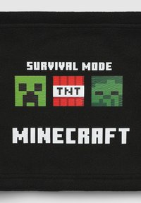 Coperta in pile nera con grafica a tema Minecraft: volto di Creeper, blocco TNT e un altro volto di Creeper, con le scritte "SURVIVAL MODE" e "MINECRAFT".