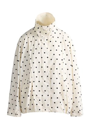 Cream-colored long-sleeve jacket with black polka dots, high collar, front button closure, and elastic hem and cuffs.
