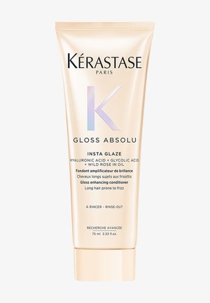 Kérastase Gloss Absolu conditioner in een gouden tube van 75 ml heeft een glanzende afwerking, met witte en iriserende accenten en duidelijke productlabeling.