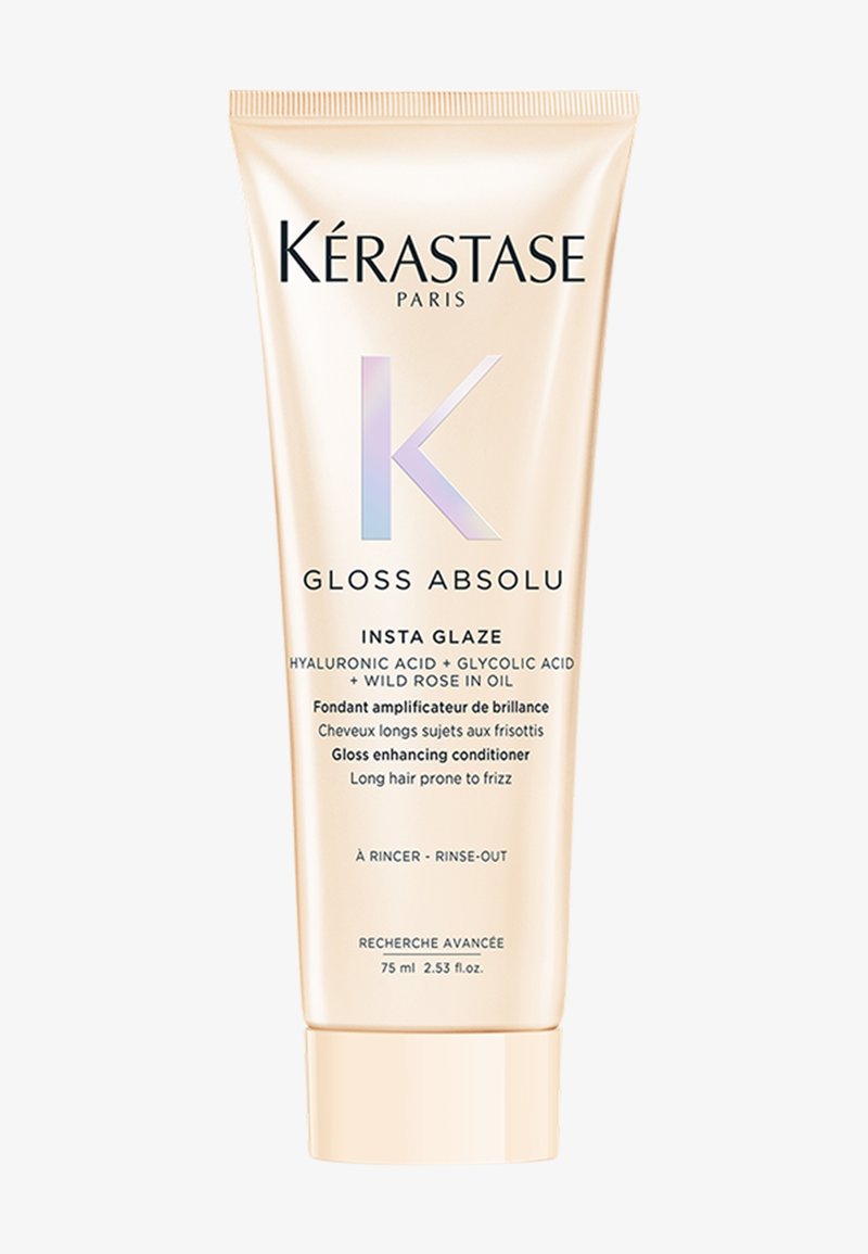 Kérastase Gloss Absolu conditioner in een gouden tube van 75 ml heeft een glanzende afwerking, met witte en iriserende accenten en duidelijke productlabeling.