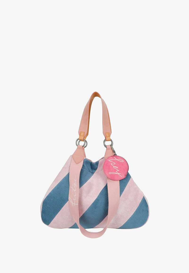 Canvas tas met roze en blauwe diagonale strepen, roze leren handvatten en een ronde roze label met de tekst "hey." Zachte textuur met een slonzig model.