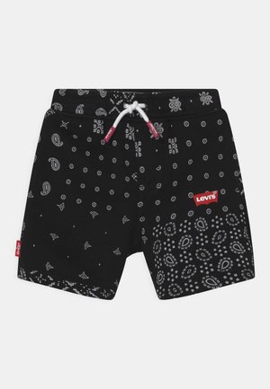 Schwarze Shorts mit weißen Paisley- und kleinen Blumenmustern, weißem Kordelzug mit roten Spitzen und rotem Levi's-Logo am rechten Bein.