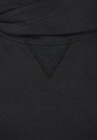 Black, cotton fabric with a textured triangular neckline detail, featuring fine ribbing and stitching accents. Smooth surface with a matte finish.