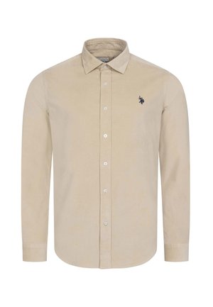 Beige long-sleeve button-up shirt with collar and small dark embroidered logo on the left chest.